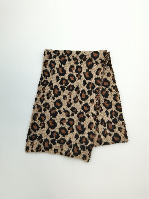 Folded beige and brown leopard print knitted neck warmer snood scarf on white background - custom packaging design free