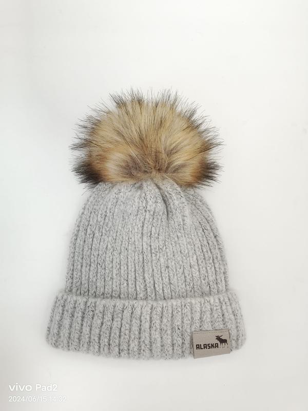 Light gray chunky ribbed knit winter beanie hat with large faux fur pom pom on white background - BSCI + Oeko-Tex + GRS certified