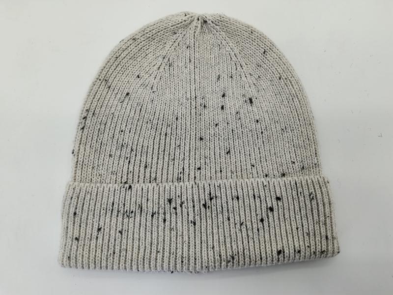 Light grey knit beanie hat with black speckle fleck pattern and folded ribbed cuff, laid flat on white background - wholesale price for Europe buyers