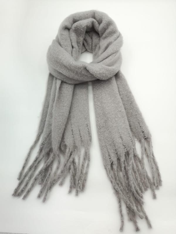 Light grey cozy knit winter scarf looped and displayed flat, featuring long fringe tassels on both ends, on white background - factory direct price no middleman