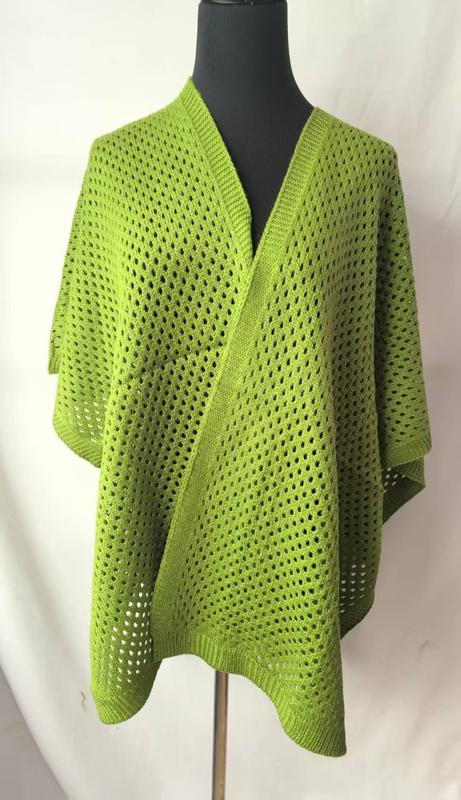 Lime green open-weave knit wrap poncho with V-neckline and ribbed hem displayed on a black mannequin - BSCI audit passed supplier