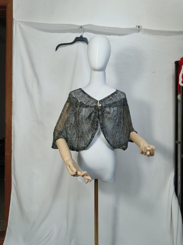 Metallic blue and gold open-weave knit capelet shawl displayed on white mannequin with pearl button closure - wholesale price for Europe buyers