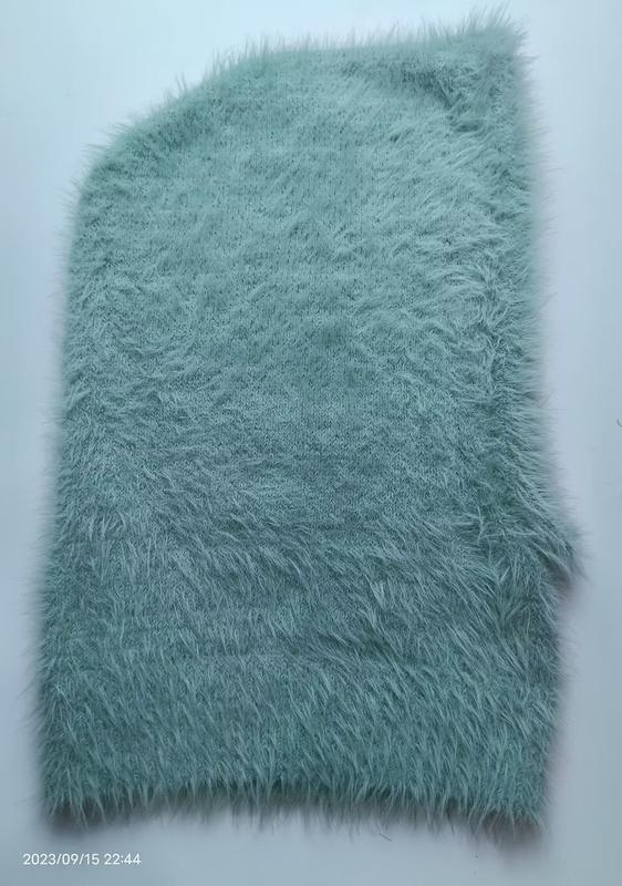Mint green shaggy faux fur knit fabric swatch laid flat on white background, showing fluffy long-pile texture - corporate gift customization