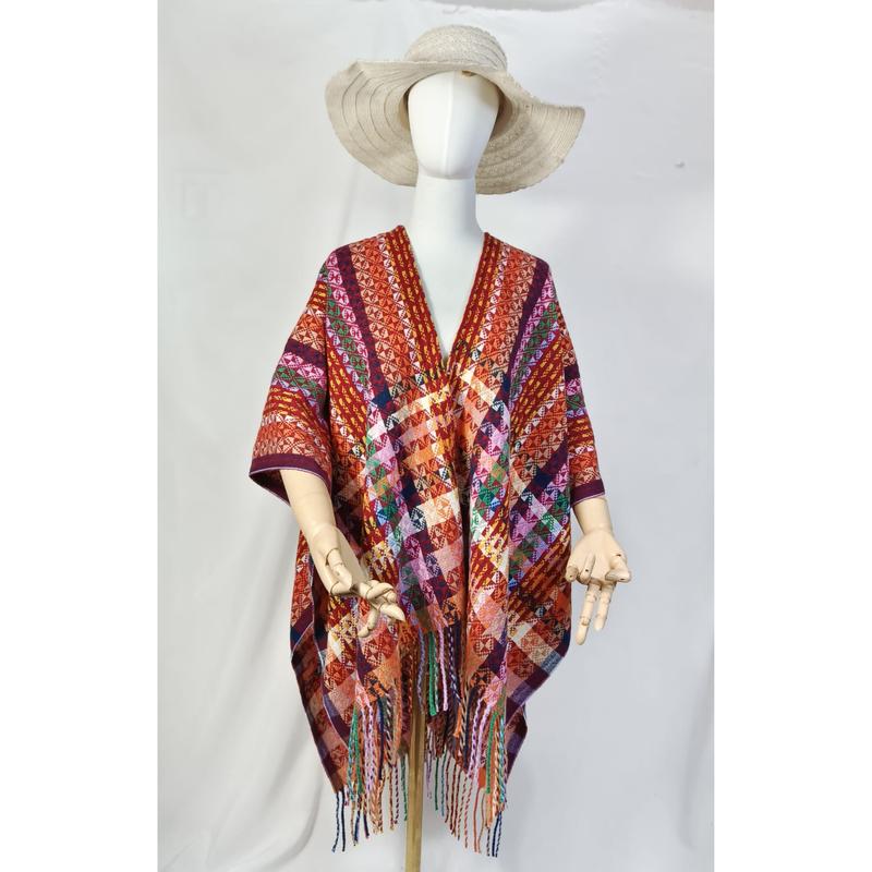 Multicolor handwoven geometric pattern open-front poncho with colorful fringe hem displayed on mannequin with wide-brim hat - sample order 10pcs available