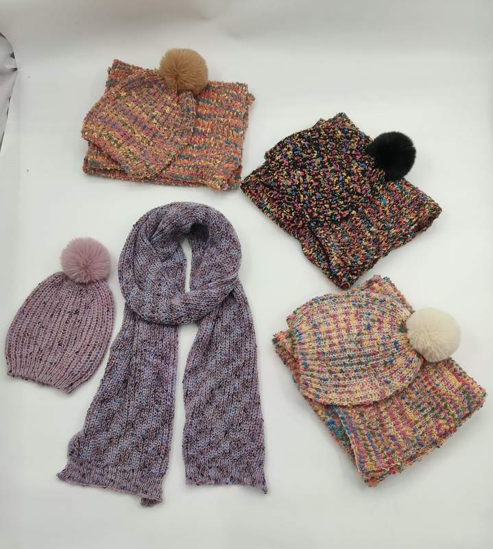 Four knitted winter hat and scarf sets in multicolor speckled yarn with faux fur pompoms, plus a purple knit beanie and long scarf - boutique retail bulk order