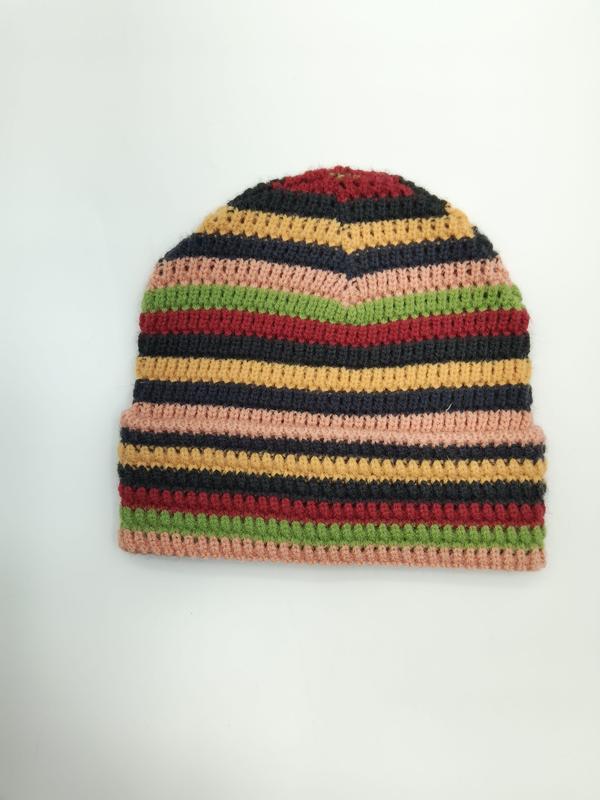 Handmade multicolor striped crochet beanie hat in pink, green, red, yellow, and black on white background - retail buyer inquiry welcome - event merchandise supplier