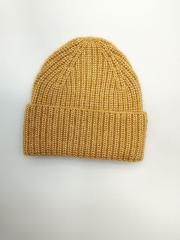 Mustard yellow chunky ribbed knit winter beanie hat with folded cuff laid flat on white background - bulk order 20-day delivery