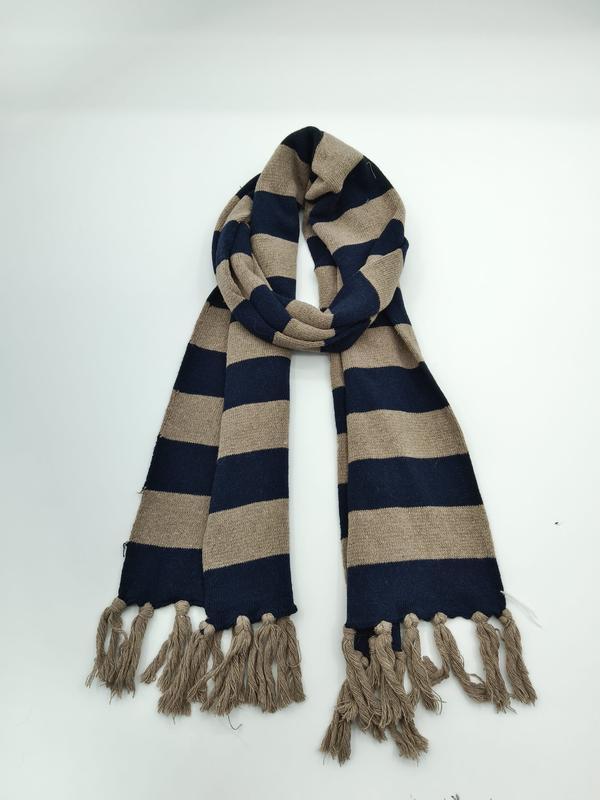Striped navy blue and beige knit winter scarf looped on white background with tassel fringe ends - EU REACH compliant material