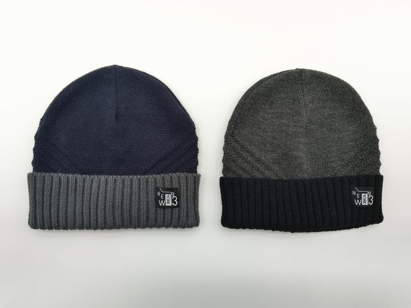 Two knit beanies side by side: navy blue with grey ribbed cuff and charcoal grey with black ribbed cuff, both with New York 93 label - email us get price list now