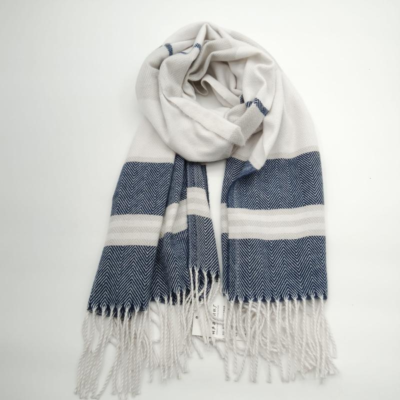 Navy blue and cream herringbone woven scarf with bold stripes and tassel fringe ends, coiled on white background - certified scarf manufacturer China