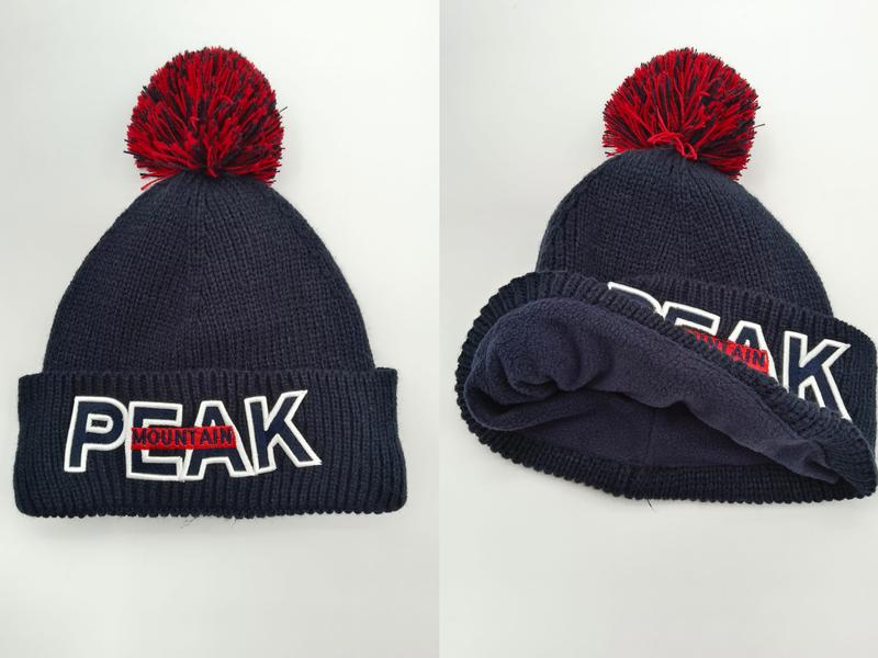 Navy blue ribbed knit beanie with red pom-pom and embroidered PEAK MOUNTAIN logo on folded cuff, front and interior view - free sample within 7 days