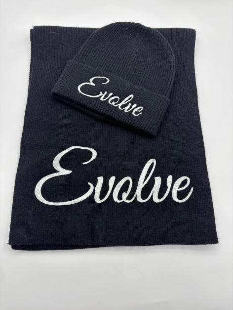 Navy blue knit beanie hat and matching scarf set with white cursive script embroidery on white background - custom packaging design free