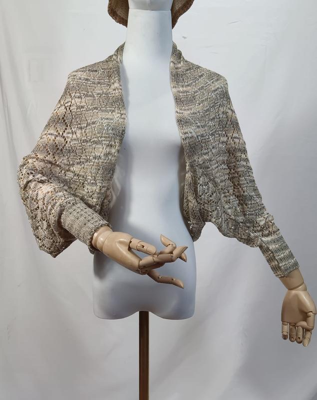 Lace knit open-front shrug bolero in beige grey marl displayed on a mannequin with wooden articulated hands - corporate gift customization
