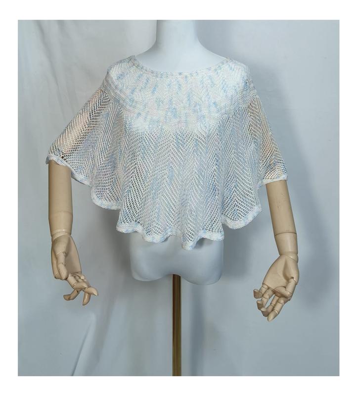 White and light blue open-weave crochet mesh poncho cape top displayed on a mannequin with wooden arms - ask bulk pricing get discount