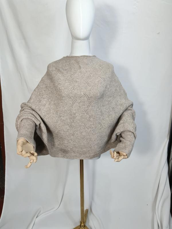Oversized oatmeal beige pointelle knit batwing sweater displayed on mannequin with wooden hand props, back view - custom packaging design free