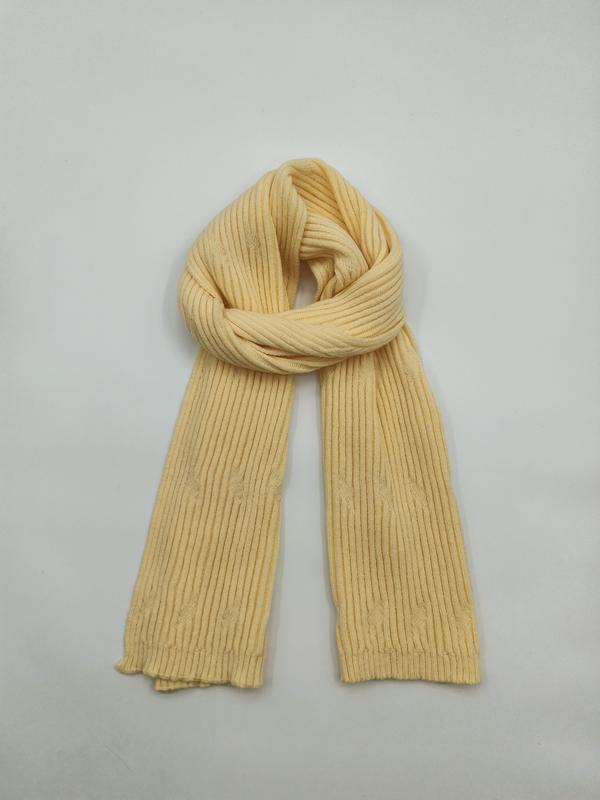 Pale yellow ribbed knit scarf looped and laid flat on white background, showing fine vertical rib texture - factory direct price no middleman
