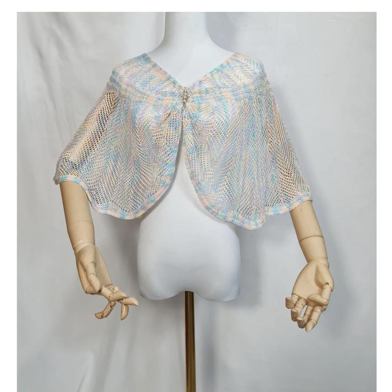 Pastel blue pink cream open-knit mesh capelet shawl with rhinestone brooch closure on white dress form mannequin - corporate gift customization