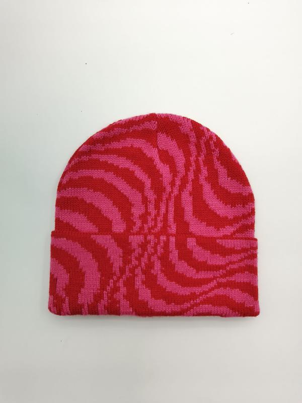 Flat lay of a pink and red zebra stripe knit beanie hat with folded cuff on white background - certified scarf manufacturer China - air shipping 5-7 days arrival