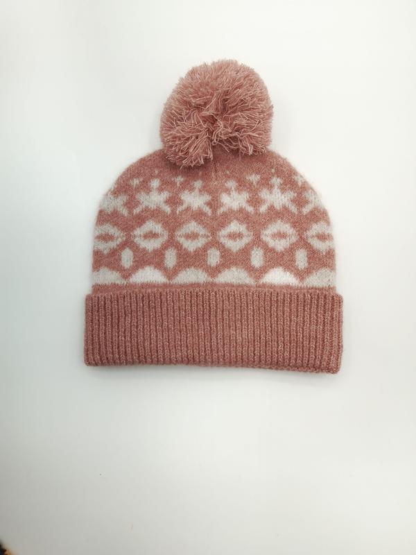Pink and white Fair Isle knitted beanie hat with fluffy pom pom and geometric snowflake pattern on white background - winter accessories wholesaler