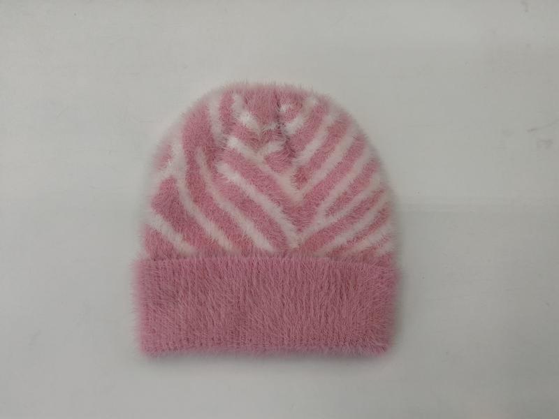 Pink fluffy knit beanie hat with white zebra stripe pattern and folded cuff, laid flat on white background - custom packaging design free