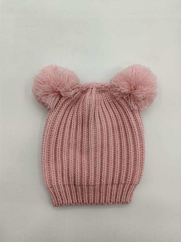 Pink ribbed knit baby beanie hat with two fluffy pom-poms on top, laid flat on white background - BSCI audit passed supplier