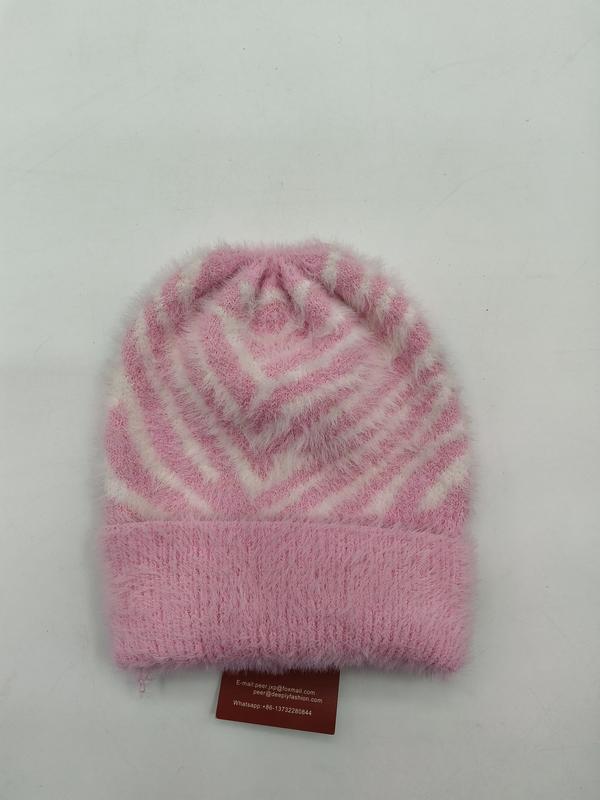 Pink and white fuzzy knit beanie hat with geometric chevron stripe pattern and folded cuff, laid flat on white background - boutique retail bulk order