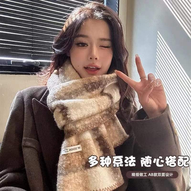 Young woman wearing a cozy beige and brown plaid fuzzy knit scarf with double-sided design, styled over a dark wool coat indoors - EU REACH compliant material