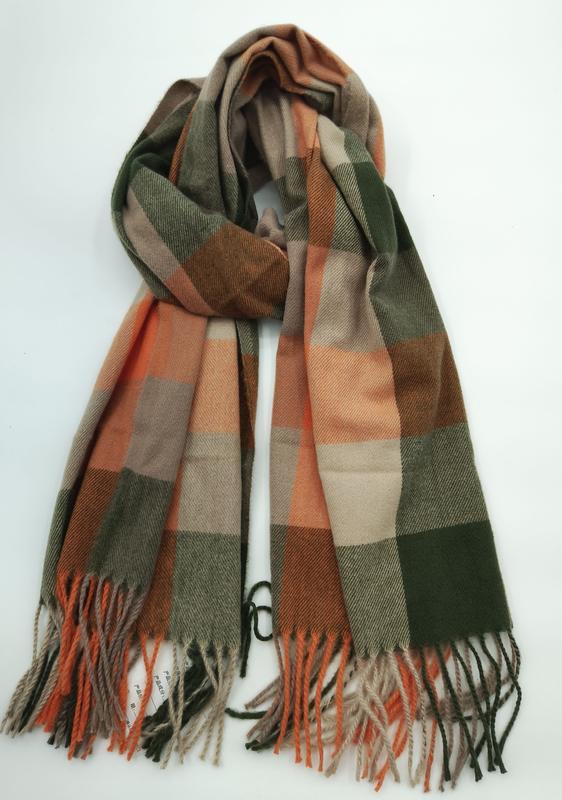 Folded plaid scarf in olive green, burnt orange, and beige large check pattern with twisted fringe ends on white background - BSCI + Oeko-Tex + GRS certified