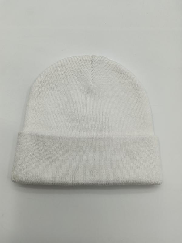 Plain white ribbed knit cuffed beanie hat laid flat on white surface, showing folded brim and seamed crown - wholesale price for Europe buyers
