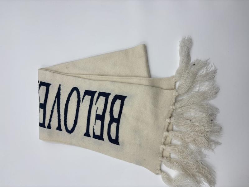 Oversized plaid blanket scarf with soft fringe trim folded on white background for wholesale winter accessories