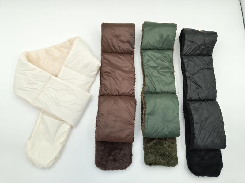 Four quilted puffer scarves with faux fur lining laid flat in cream, brown, olive green, and black colorways - factory direct price no middleman