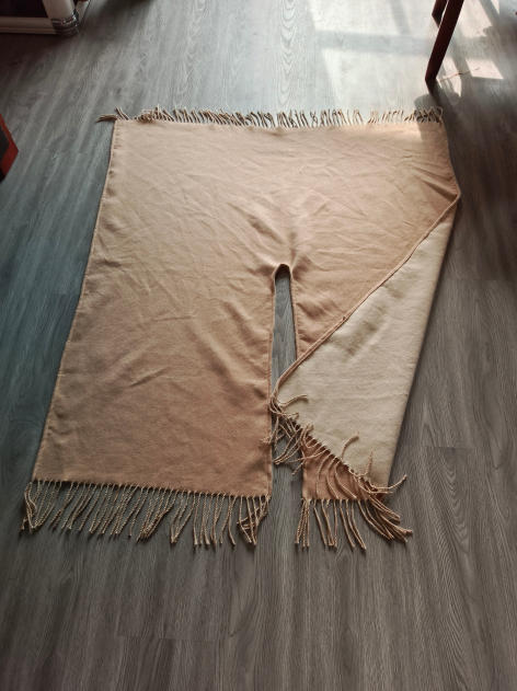 Reversible beige and cream woven throw blanket with twisted rope fringe trim laid flat on hardwood floor - bulk order 500+ pcs extra 8% off