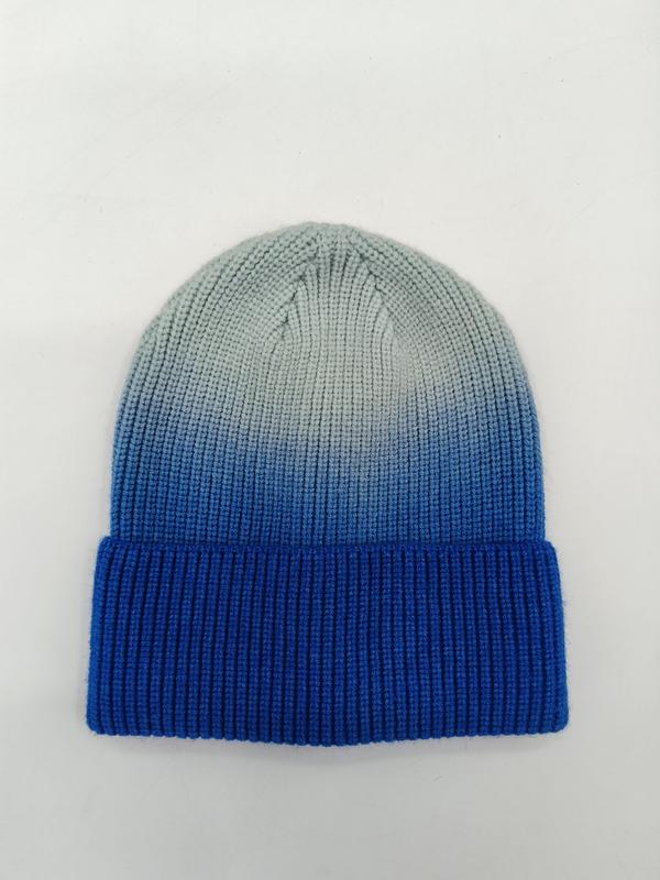 Ribbed knit cuffed beanie hat with blue to grey ombre dip-dye gradient effect, laid flat on white background - gift shop wholesale supplier
