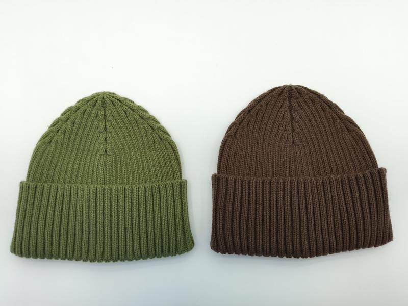 Two ribbed knit beanie hats laid flat on white background, one olive green and one brown, both with folded cuffs - low MOQ 50pcs trial order