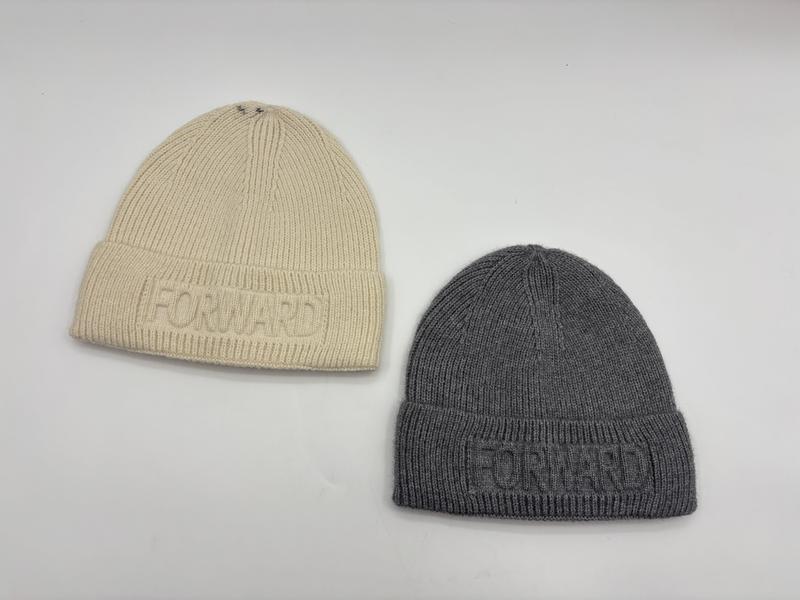 Two ribbed knit beanie hats in cream and grey with embossed Forward logo on folded cuff, laid flat on white surface - event merchandise supplier