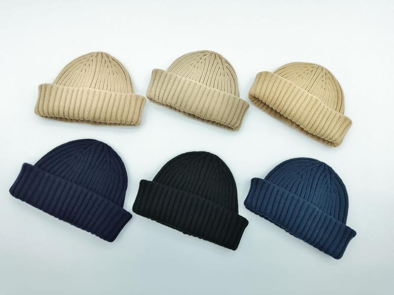 Six ribbed knit folded cuff beanies arranged in two rows in beige, navy, black, and steel blue colorways on white background - ODM OEM service available - ISO 9001 quality controlled