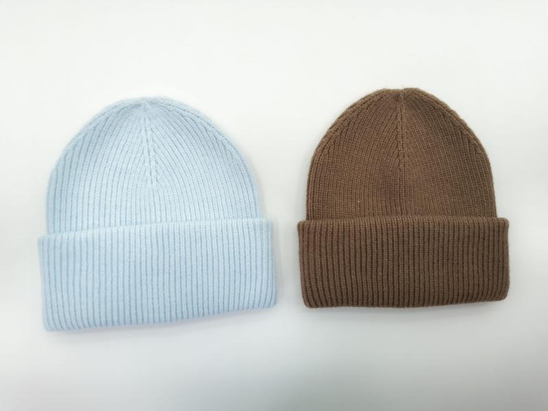 Two ribbed knit beanies side by side, one in baby blue and one in caramel brown, with folded cuffs on white background - event merchandise supplier