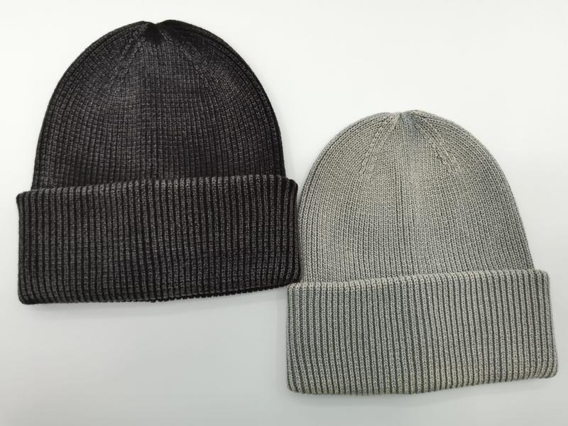 Two ribbed knit cuffed beanie hats side by side, one charcoal dark grey and one light grey, on white background - winter accessories wholesaler