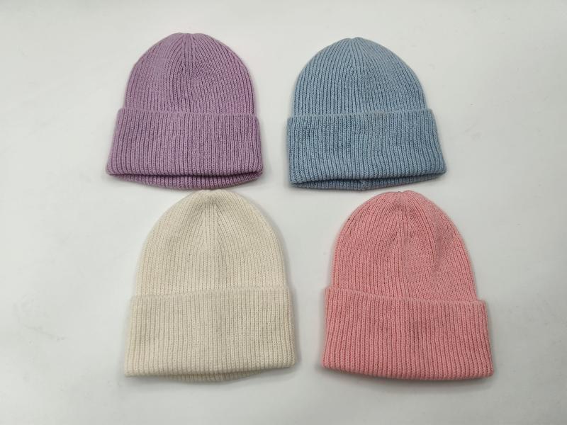 Four ribbed knit cuffed beanie hats in pastel lavender, blue, cream, and pink laid flat on white surface - 5-day digital sample ready