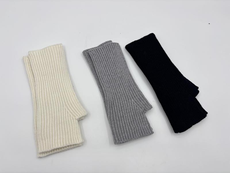 Three ribbed knit fingerless gloves arm warmers laid flat in ivory, grey, and black on white background - private label service available