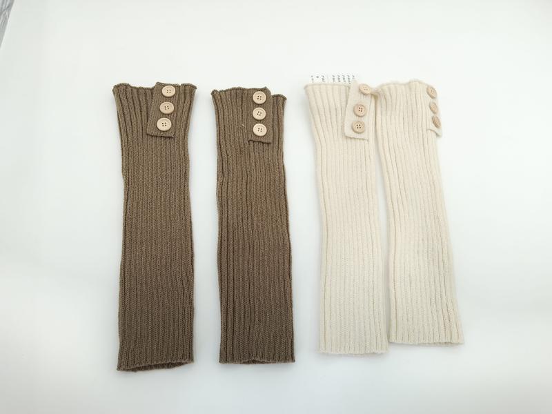 Two pairs of ribbed knit leg warmers with wooden buttons at top, one taupe and one cream, laid flat on white background - ODM OEM service available - EU REACH compliant material