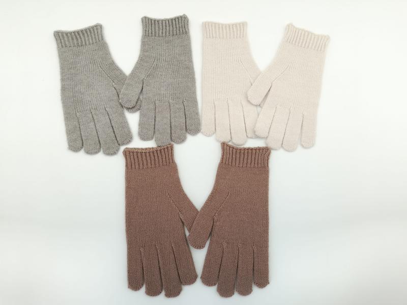 Three pairs of ribbed knit winter gloves in light grey, cream, and mauve pink laid flat on white background - no MOQ for stock designs