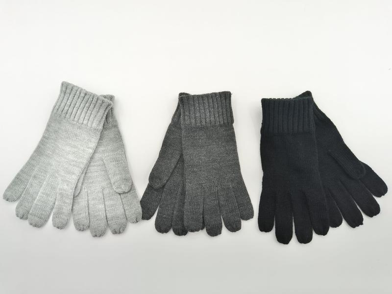 Three pairs of ribbed knit winter gloves in light gray, charcoal gray, and black laid flat on white background - winter accessories wholesaler