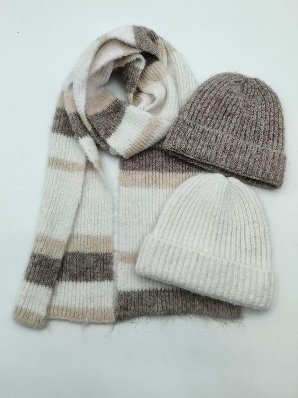 Flat lay of a striped knit scarf in cream, beige and taupe with two ribbed wool beanies in grey and ivory - winter accessories wholesaler
