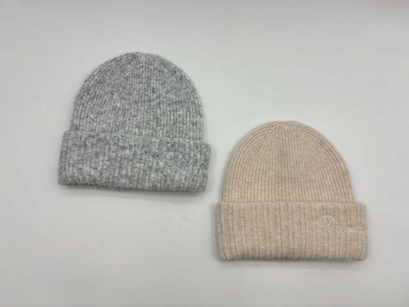 Two ribbed knit wool blend beanie hats with folded cuff, one in heather grey and one in cream beige, shown on white background - hotel amenity scarf supplier