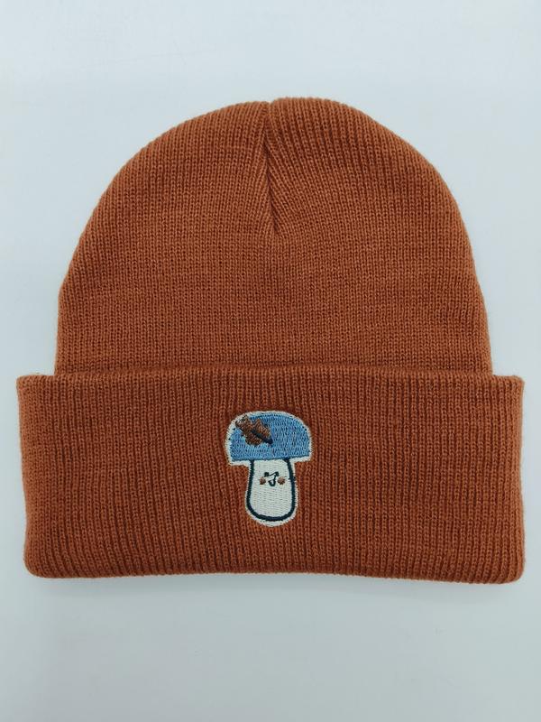 Rust orange ribbed knit cuffed beanie hat with blue and white embroidered mushroom patch on folded brim - factory direct price no middleman