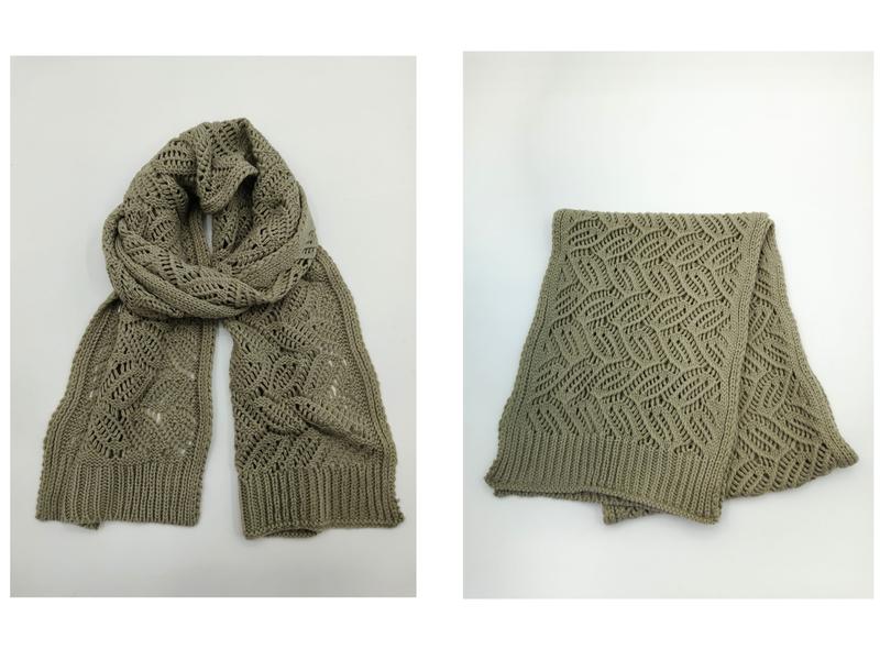 Sage green knit scarf with open lace diamond pattern and ribbed edges, shown draped and folded on white background - custom logo label accepted