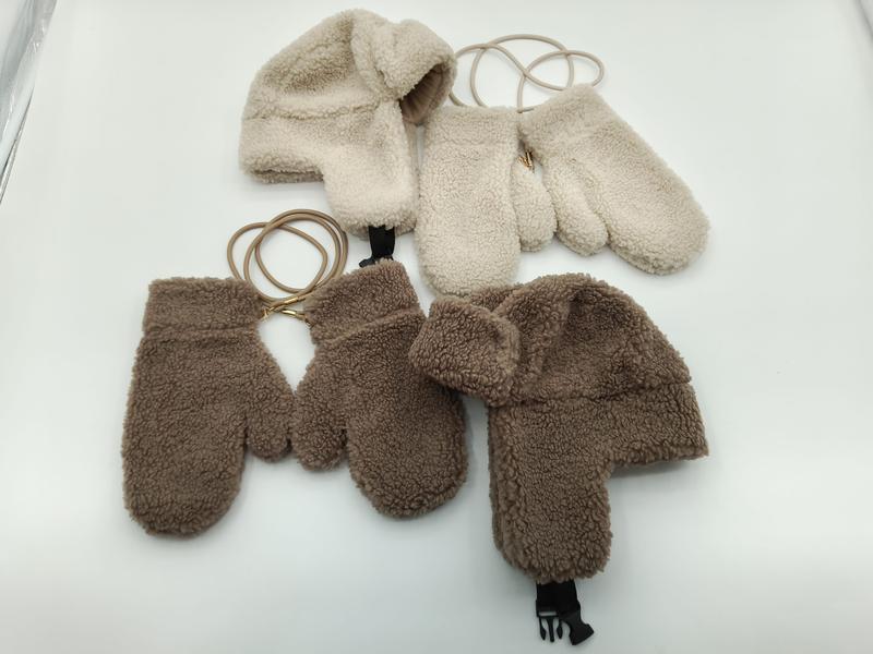 Two sherpa fleece trapper hat and mitten sets in cream and brown, connected by elastic cords, laid flat on white surface - email us get price list now
