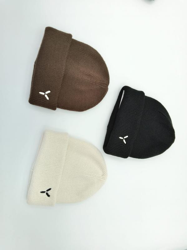Three folded cuffed knit beanies in brown, black, and cream with small embroidered logo on white background - bulk order 20-day delivery