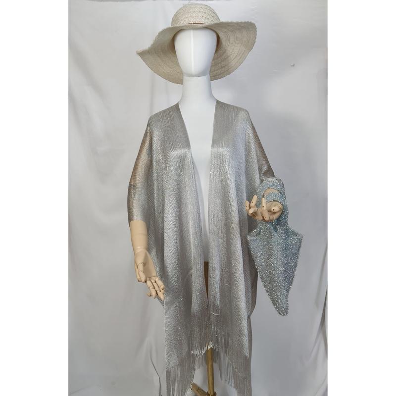 Mannequin wearing silver metallic open-front kimono wrap with fringe hem, wide-brim straw hat, and blue glitter bag - custom logo label accepted